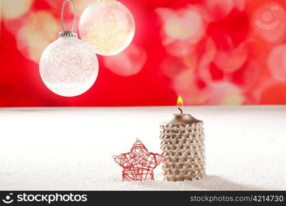 christmas silver candle and red star on snow and red with glass baubles