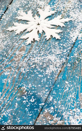 Christmas snowflake ornament on rustic style grunge background