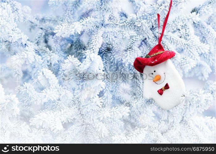Christmas Snowman Sock Hanging on a Tree Branch in the Snow Winter Forest