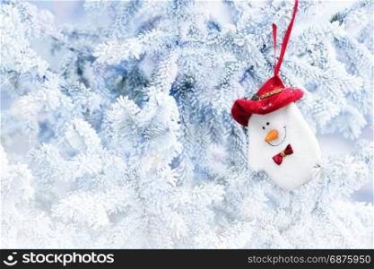 Christmas Snowman Sock Hanging on a Tree Branch in the Snow Winter Forest