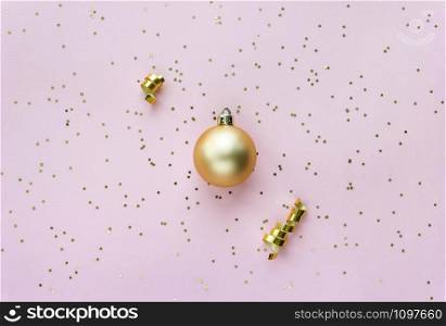Christmas sparkles composition. Christmas ball and golden stars on pastel pink background. Christmas sparkles composition. Christmas ball and golden stars on pastel pink background.