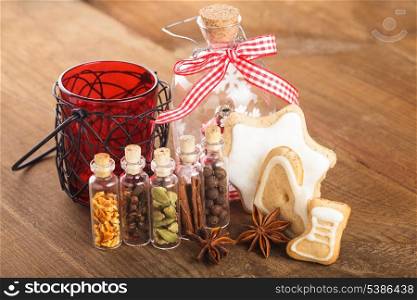 Christmas spices for mulled wine or ginger cookies in small decorative bottles