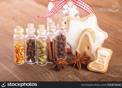 Christmas spices for mulled wine or ginger cookies in small decorative bottles