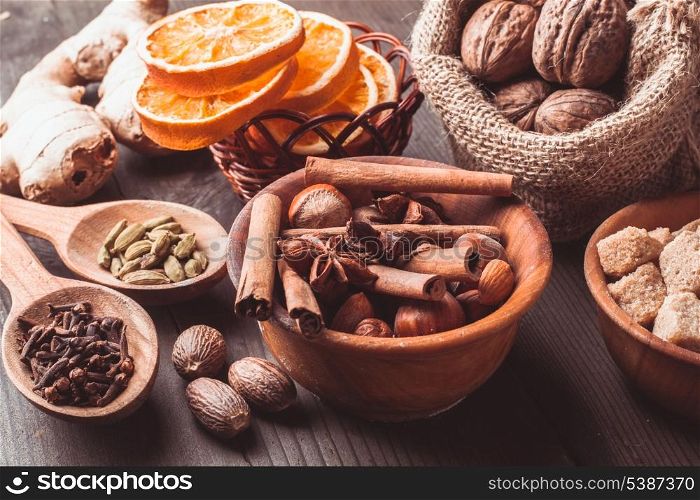 Christmas spices - nuts, brown sugar, dried orange, kandamon, cloves, cinnamon, nutmeg, ginger and anise