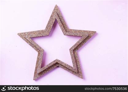 Christmas star decorations on pink plain background. Christmas decorations on pink