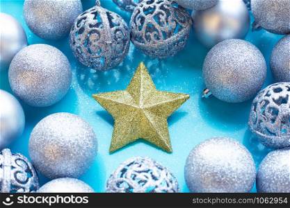 Christmas star with baubles decoration on blue background.