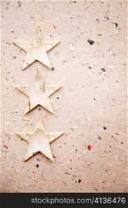 christmas stars on recycled paper background as an ecology metaphor