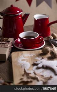 christmas still life. background from gingerbread in the form of an elk on a wooden table on the background of a cup, teapot