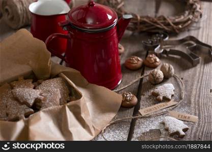 christmas still life. gingerbread in a box on the background of a cup, teapot