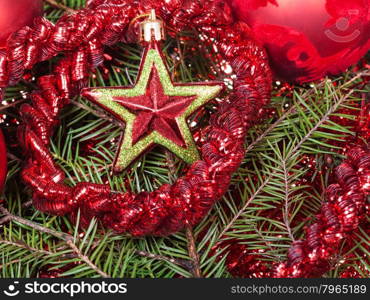 Christmas still life - red star, Christmas baubles, tinsel on Xmas tree background