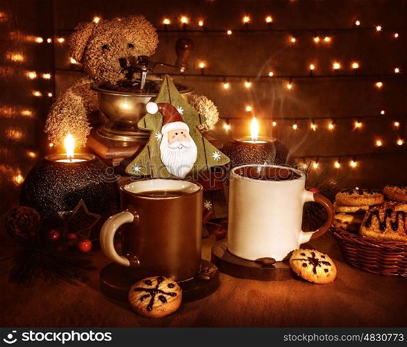 Christmas still life, tasty traditional dessert, two cups of coffee with tasty cookie, teddy bear and little decorative Xmas tree toy with Santa Claus face