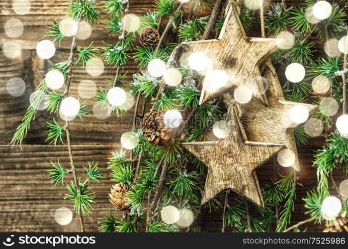 Christmas still life wooden ornaments and pine tree branches. Vintage style decorations. Retro toned with light effect