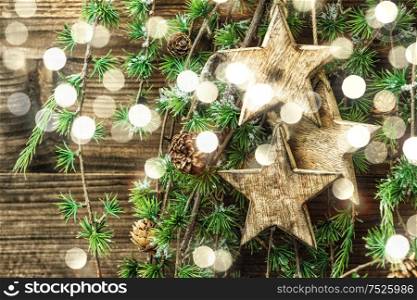 Christmas still life wooden ornaments and pine tree branches. Vintage style decorations. Retro toned with light effect