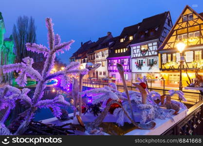 Christmas street at night, Colmar, Alsace, France. Traditional Alsatian half-timbered houses in Petite Venise, old town of Colmar, decorated and illuminated at christmas time, Alsace, France