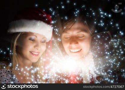 Christmas surprise. Man presenting to woman red gift box