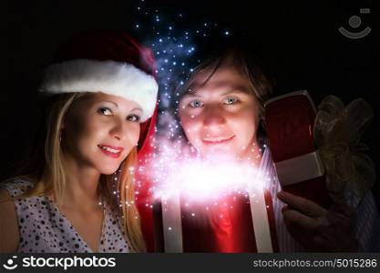 Christmas surprise. Man presenting to woman red gift box