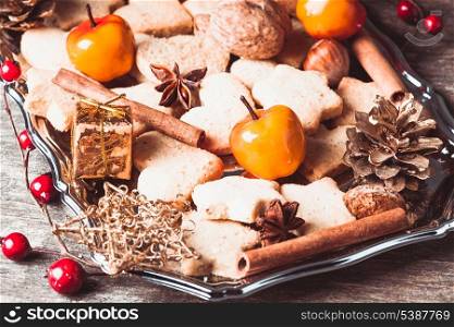 Christmas sweet decor - cookies, apple and spices on the tray