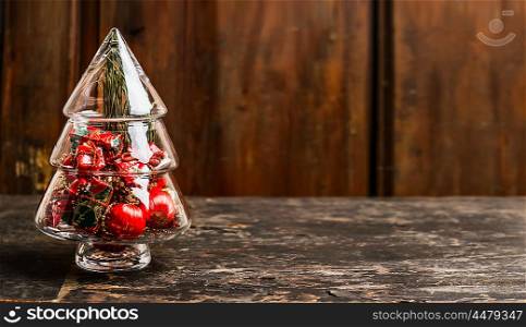 Christmas symbol tree from glass with decoration on rustic table over wooden background, banner