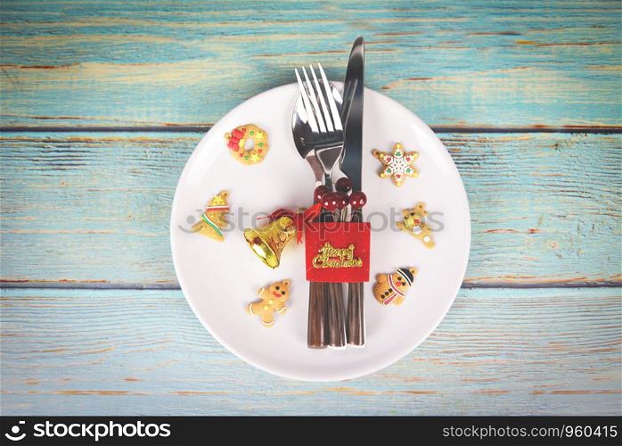 Christmas table place setting decoration with fork spoon and knife on white plate Xmas New Year food lunch festive Christmas dinner holidays background themed party