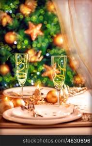 Christmas table setting, festive dinner still life and beautiful decorated Xmas tree at home, New Year eve, luxury wintertime party concept
