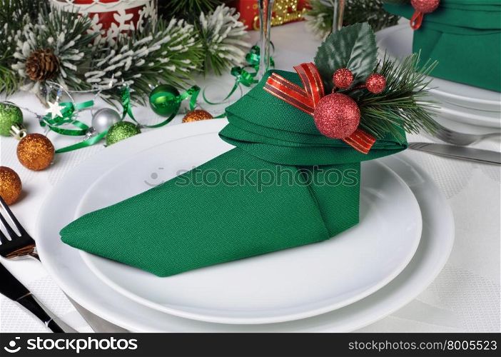 Christmas table setting with a napkin in the form of Elven boots