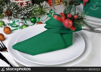 Christmas table setting with a napkin in the form of Elven boots
