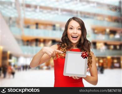 christmas, technology, present and people concept - smiling woman in red dress with blank tablet pc computer screen over shopping centre background