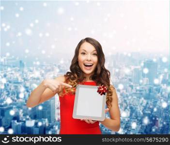 christmas, technology, present and people concept - smiling woman in red dress with blank tablet pc computer screen over snowy city background