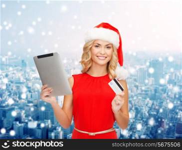 christmas, technology, shopping and people concept - smiling woman in santa helper hat with tablet pc computer and credit card over snowy city background