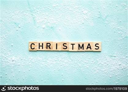 Christmas text design background. Wooden sign in snow written text top view, Holiday,merry Christmas concept background copy space. Christmas text design background. Wooden sign in snow written text top view, Holiday,merry Christmas concept background