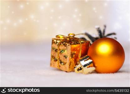 christmas things as ctrobiles and gold present and ball on white