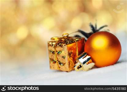 christmas things as ctrobiles and gold present and ball on white