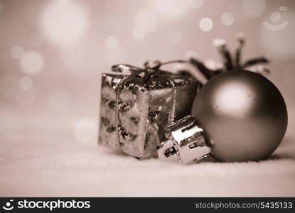 christmas things as ctrobiles and gold present and ball on white, black and white.