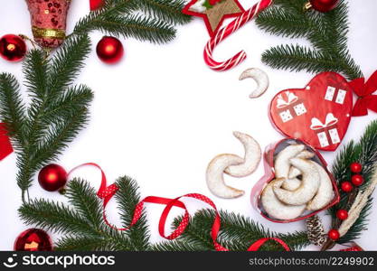 Christmas top view frame composition with copy space - branches, candy cookies and balls. High quality photo. Christmas top view frame composition with copy space - branches, candy cookies and balls