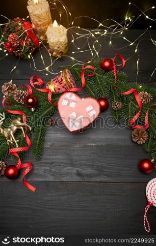 Christmas top view frame composition with copy space - branches, candy cookies and balls. High quality photo. Christmas top view frame composition with copy space - branches, candles, gift box and garland