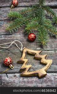 Christmas toy, vintage wooden Christmas tree on background with Christmas fir