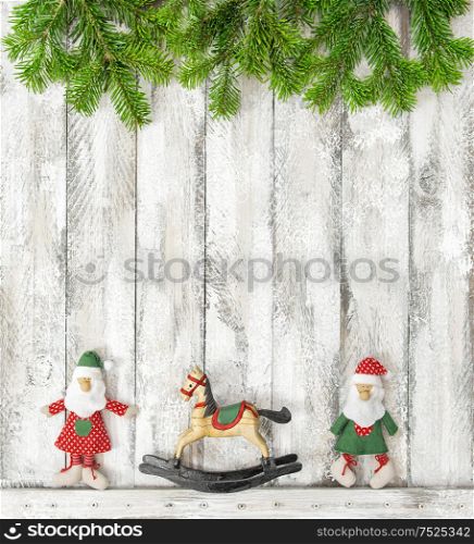 Christmas toys decoration on rustic wooden background. Christmas holidays banner with tree branches