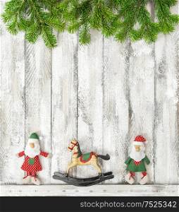 Christmas toys decoration on rustic wooden background. Christmas holidays banner with tree branches