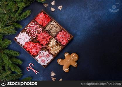 Christmas toys in white and red in a wooden sectional box against a dark concrete background. Home decorations for Christmas holiday. Christmas toys in white and red in a wooden sectional box against a dark concrete background