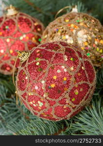 Christmas toys on branches of a fur-tree. Celebratory background