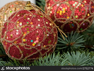 Christmas toys on branches of a fur-tree. Celebratory background