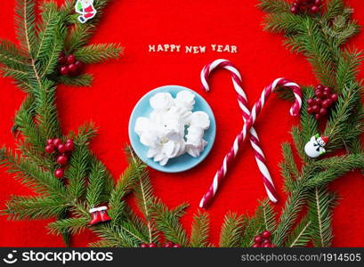 Christmas tree and candy on a red background with the words Happy New Year.. Christmas tree and candy on a red background with the words Happy New Year