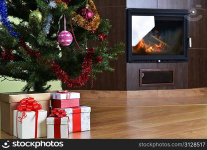 Christmas tree and christmas gift boxes in interior with fireplace