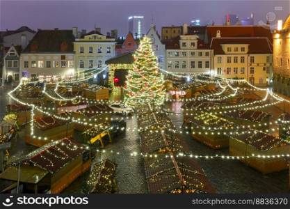 Christmas tree and Christmas Market at Town Hall Square in Tallinn, Estonia. Aerial view. Christmas Market in Tallinn, Estonia