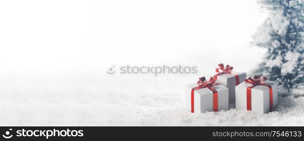 Christmas tree and gift boxes on snow isolated on white background. Christmas tree and gifts
