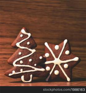 Christmas tree and snowflake. Beautiful sweet Christmas candy. Hand-decorated, homemade gingerbread.