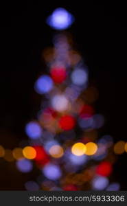 christmas tree blue, red, orange lights bokeh defocused background