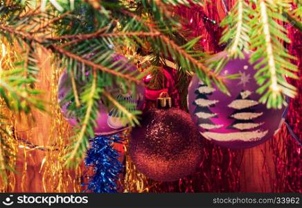 Christmas tree branch and balls on blurred background. Vintage. Christmas tree branches with Christmas balls