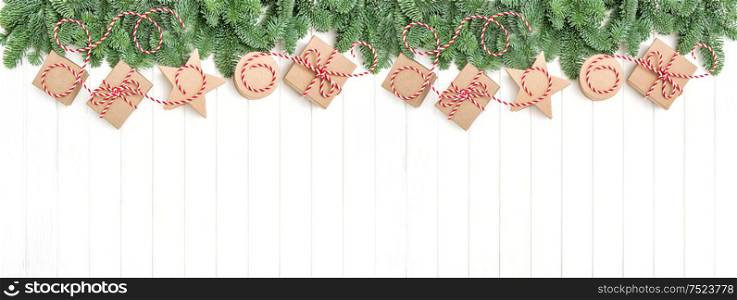 Christmas tree branches and gift boxes. Holidays banner. Flat lay