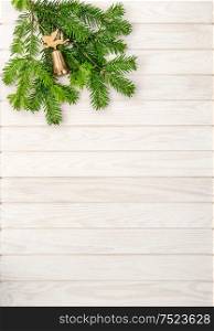 Christmas tree branches on bright wooden background. Undecorated evergreen twigs